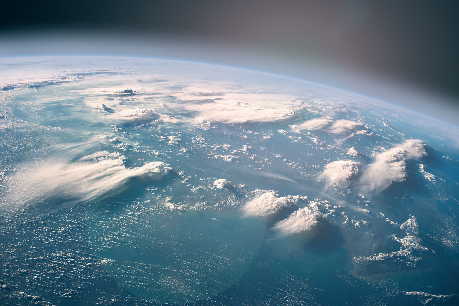 Earth viewed from space with blue oceans and white clouds in focus