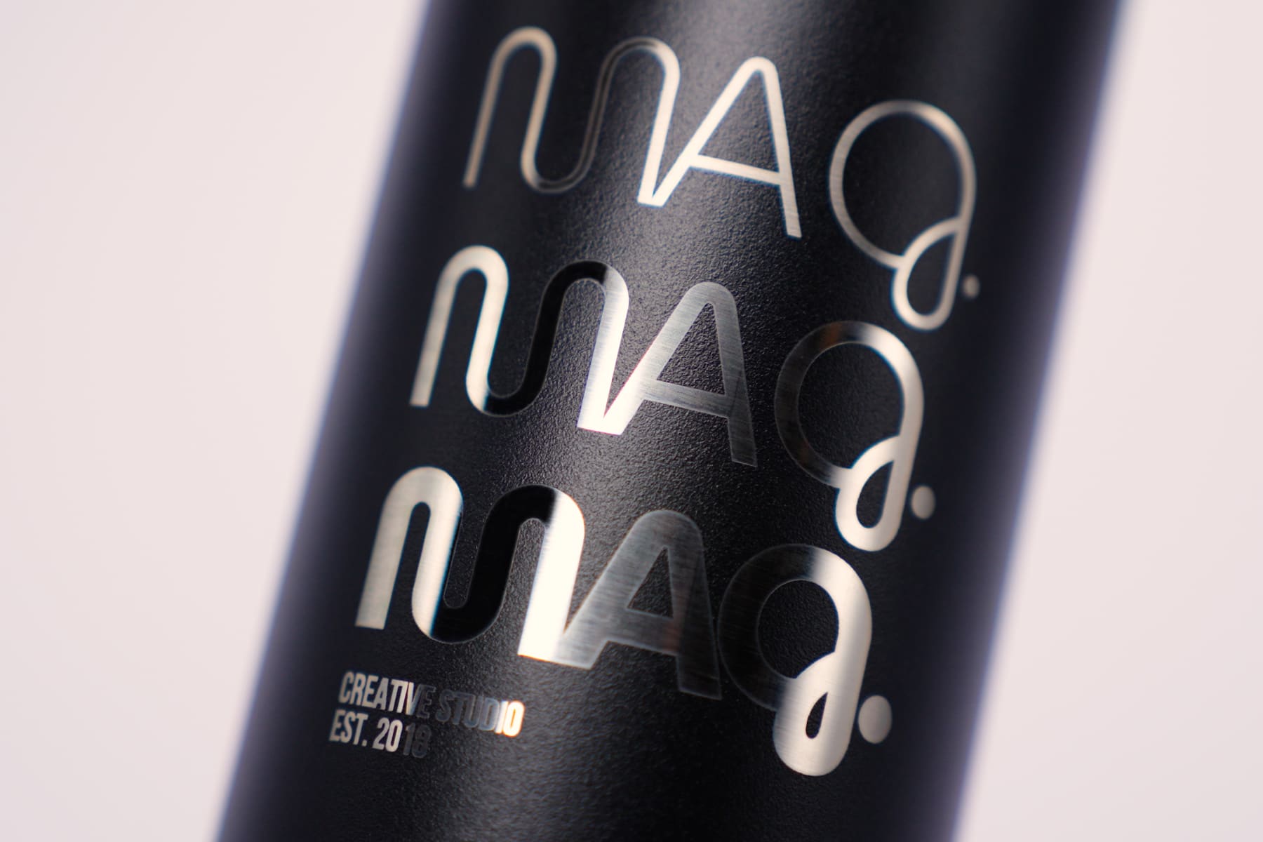 Custom water bottle of a company logo laser engraved on a black Ever Vessel