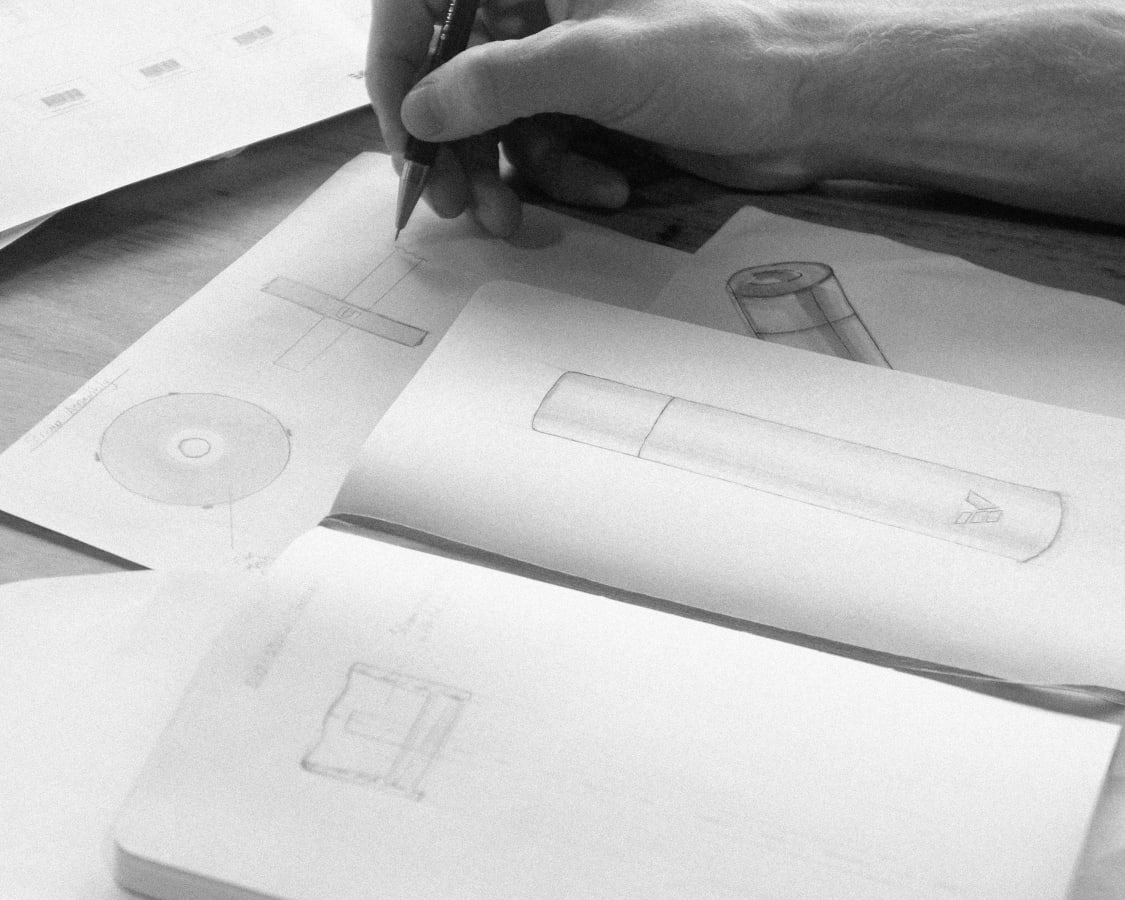 Ever Vessel founder Tim hand drawing the early drinking bottle and straw assembly concept