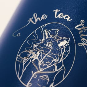 Custom water bottle of a tea company logo laser engraved on a blue Ever Vessel