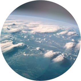 Earth viewed from space with blue oceans and white clouds in focus