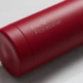 Personalized Ever Vessel stainless steel water bottle in red with laser engraved text Eric Pickleballer and emoji on the side.