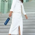 A female holding her Ever Vessel Maxi Blue stainless steel water bottle by the integrated carry handle.