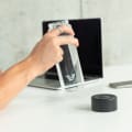 A male about to drink from his Ever Vessel Glass water bottle with a black lid at the office.