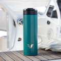 An Ever Vessel Maxi Teal Green stainless steel water bottle on the deck of a yacht.