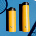 Ever Vessel Super Maxi and Maxi Yellow stainless steel water bottles on a tennis court.