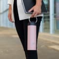 A female carrying her Ever Vessel Maxi Rose Pink stainless steel water bottle with integrated carry handle at work.