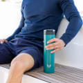 A male holding his Ever Vessel Super Maxi Teal stainless steel water bottle on the deck of a yacht.
