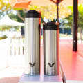 An Ever Vessel Super Maxi and Maxi stainless steel water bottles sitting on an outside table.