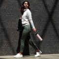 Female carrying her Ever Vessel Maxi Rose pink stainless steel water bottle by the integrated carry handle on the way to work.