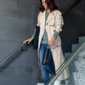 Female walking down the stairs carrying her Ever Vessel Maxi Black stainless steel water bottle by the integrated carry handle.