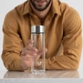 A male holding his Ever Vessel Glass water bottle with stainless steel lid in the kitchen.