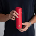 A male holding his Ever Vessel Mini Red small water bottle.