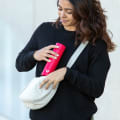 A female putting her Ever Vessel Mini Red small water bottle into a small sling.