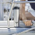 An Ever Vessel Maxi stainless steel water bottle with integrated handle and flip top on the deck of yacht.