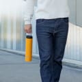 Male carrying his Super Maxi Yellow stainless steel insulated water bottle by the carry handle.