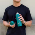Male with ever vessel multi tea flask and retractable straw in teal green
