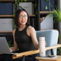 A female reaching for her Ever Vessel Multi Desert beige stainless steel tea infuser water bottle at the work cafe.