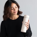 A female holding her Personalized Ever Vessel Multi Desert beige stainless steel tea infuser water bottle with the name Insabella laser engraved  on the side.