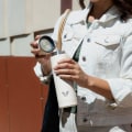 Female about to drink from her Ever Vessel Multi Desert Beige stainless steel tea infuser water bottle with the lid removed.