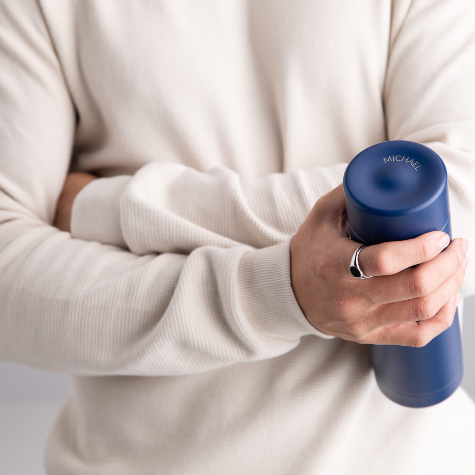A male holding a Personalized Ever Vessel Multi Blue stainless steel tea infuser water bottle with laser engraved text Michael on the lid.