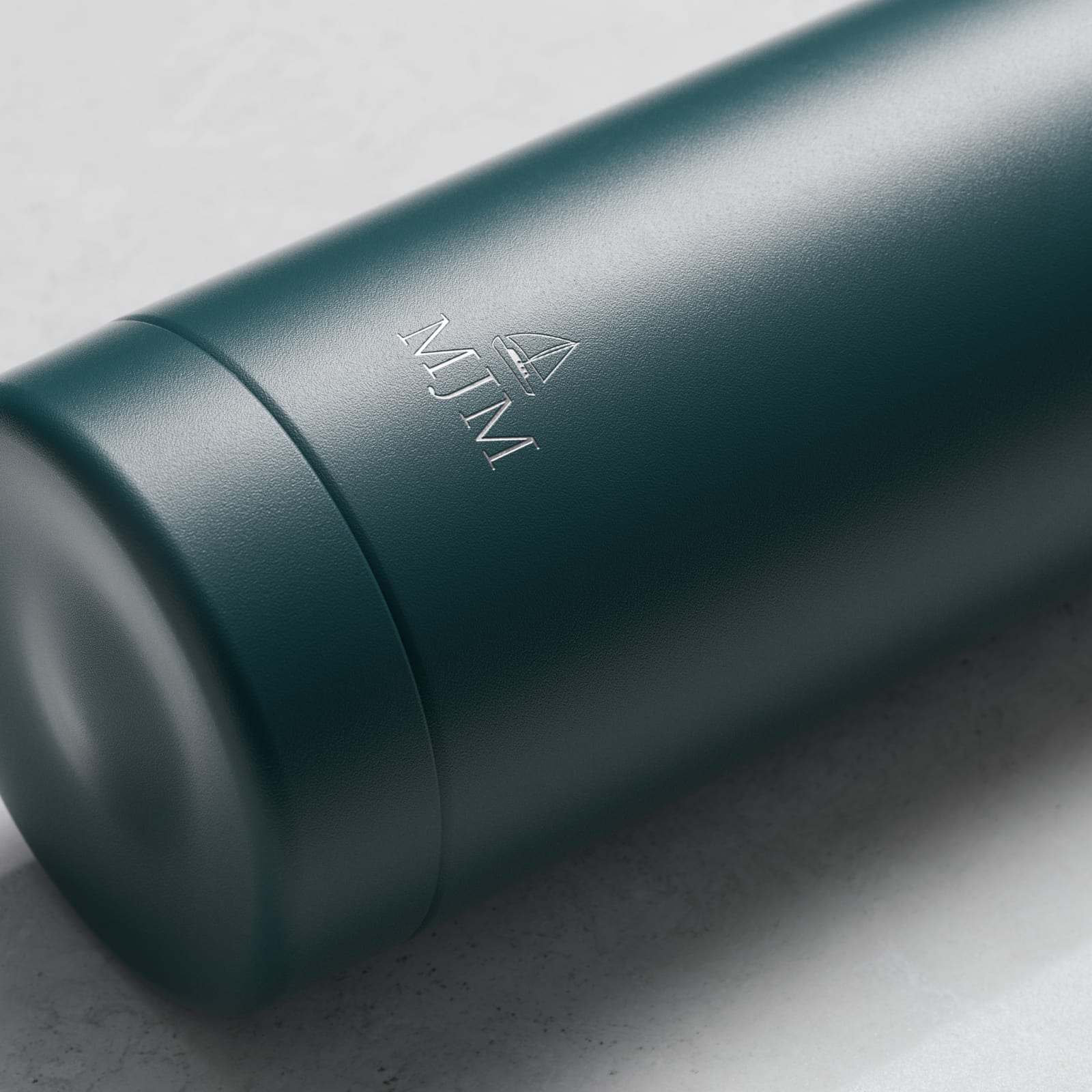 Personalized Ever Vessel stainless steel water bottle in teal green with laser engraved text MJM and emoji on the side.