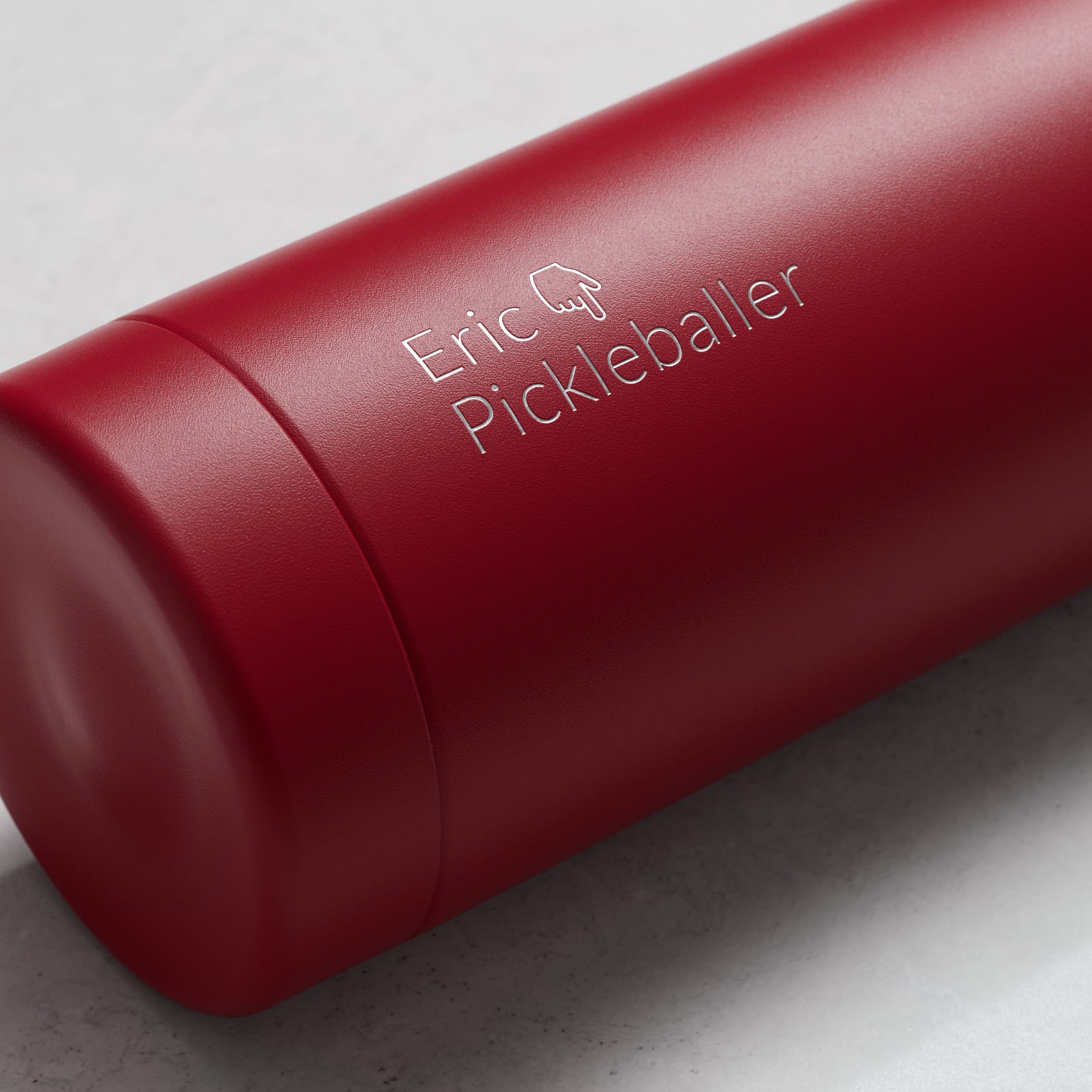 Personalized Ever Vessel stainless steel water bottle in red with laser engraved text Eric Pickleballer and emoji on the side.