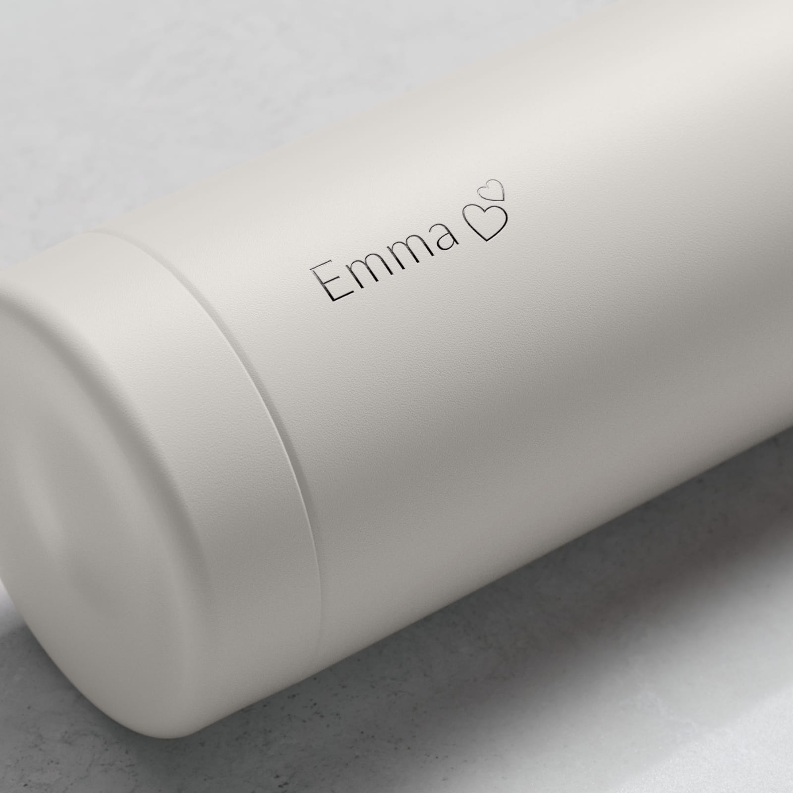 Personalized Ever Vessel stainless steel water bottle in Off White with laser engraved  text Emma and a love heart emoji on the side.