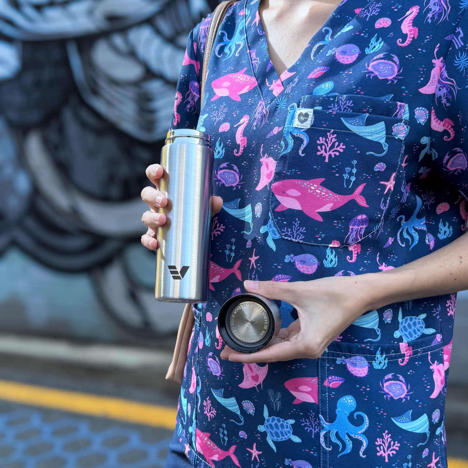 Ever Vessel Stainless Steel Mini Water bottle with no paint held by female nurse with lid off