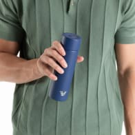 Male holding an Ever Vessel Mini Blue small water bottle.