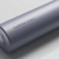 A Personalized Ever Vessel Mini Lilac small water bottle with laser engraved name Isabella Grace on the side.