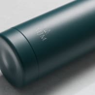 Personalized Ever Vessel stainless steel water bottle in teal green with laser engraved text MJM and emoji on the side.