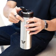 A male opening the flip top lid on his Ever Vessel Maxi stainless steel water bottle.
