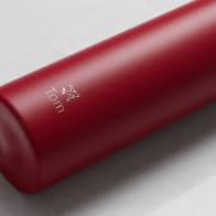 An Ever Vessel Mini Red  Personalized small water bottle with a name Tom and plane emoji engraved on the side.