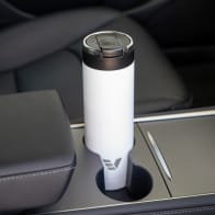 An Ever Vessel Maxi White stainless steel water bottle sitting in car cup holder.