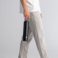 Male with an Ever Vessel Super Maxi Black Sand stainless steel water bottle, holding with the integrated handle