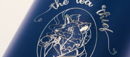 Custom water bottle of a tea company logo laser engraved on a blue Ever Vessel