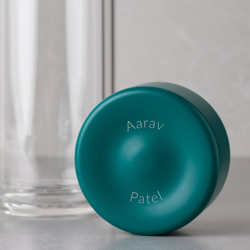Personalized Ever Vessel Glass Multi double walled glass tea infuser bottle with the teal green lid removed showing the laser engraved name.