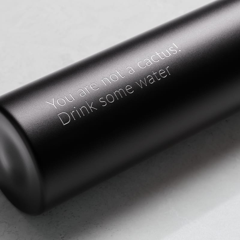 Personalized Ever Vessel Mini Black small water bottle with laser engraved text on the side.