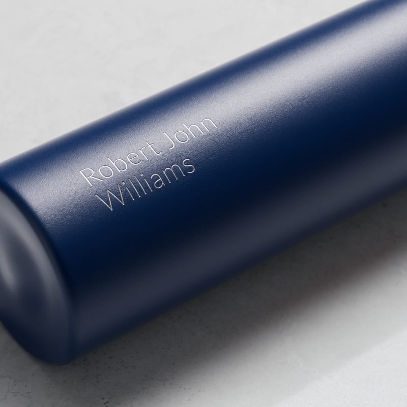 Personalized Ever Vessel Mini Blue small water bottle with laser engraved text Robert John Williams on the side.