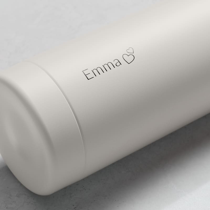 Personalized Ever Vessel stainless steel water bottle in Off White with laser engraved  text Emma and a love heart emoji on the side.