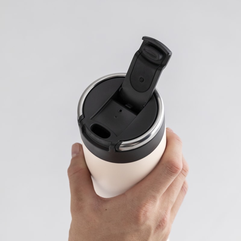 A male holding an Ever Vessel Super Maxi Luna White stainless steel water bottle with the leak-proof flip top open.