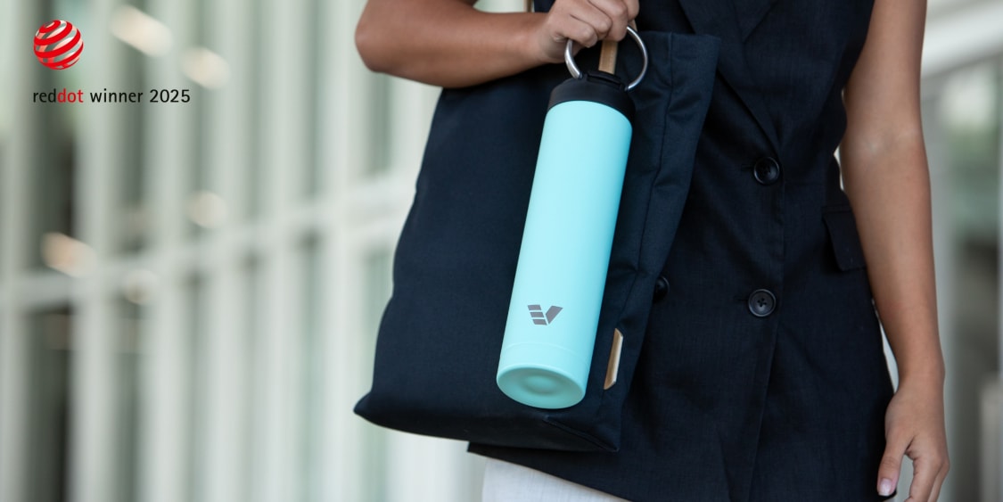 Ever Vessel Red Dot Design award blog image showing Super Maxi water bottle in mint green being carried by handle