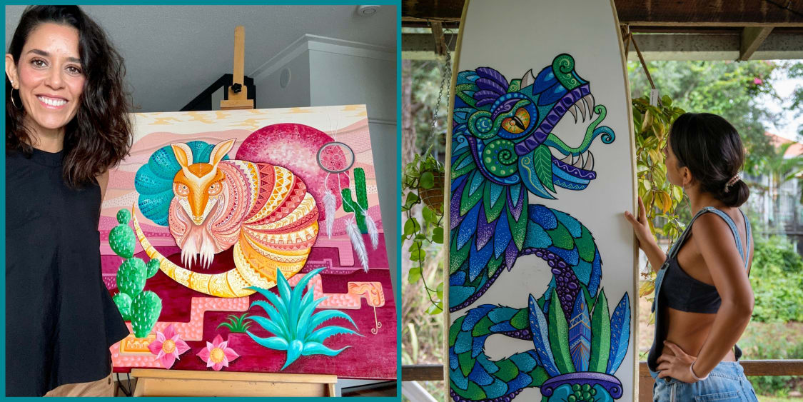 Illustrator Paola Castro standing next to her artwork on a surfboard and a canvas.