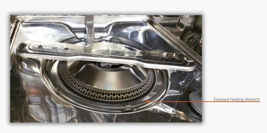 Bottom of an old style dishwasher with an exposed heating element