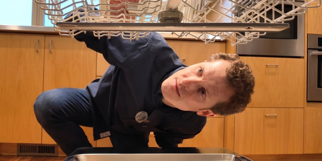 Ever Vessel founder looking at the top rack of a dishwasher