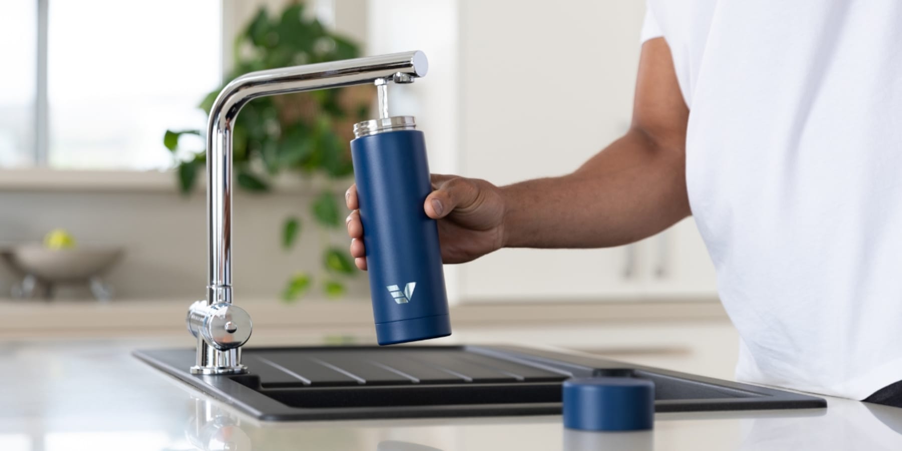 Ever Vessel Multi Water Bottle and Tea Flask Blue being filled with water