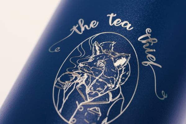 Custom water bottle of a tea company logo laser engraved on a blue Ever Vessel
